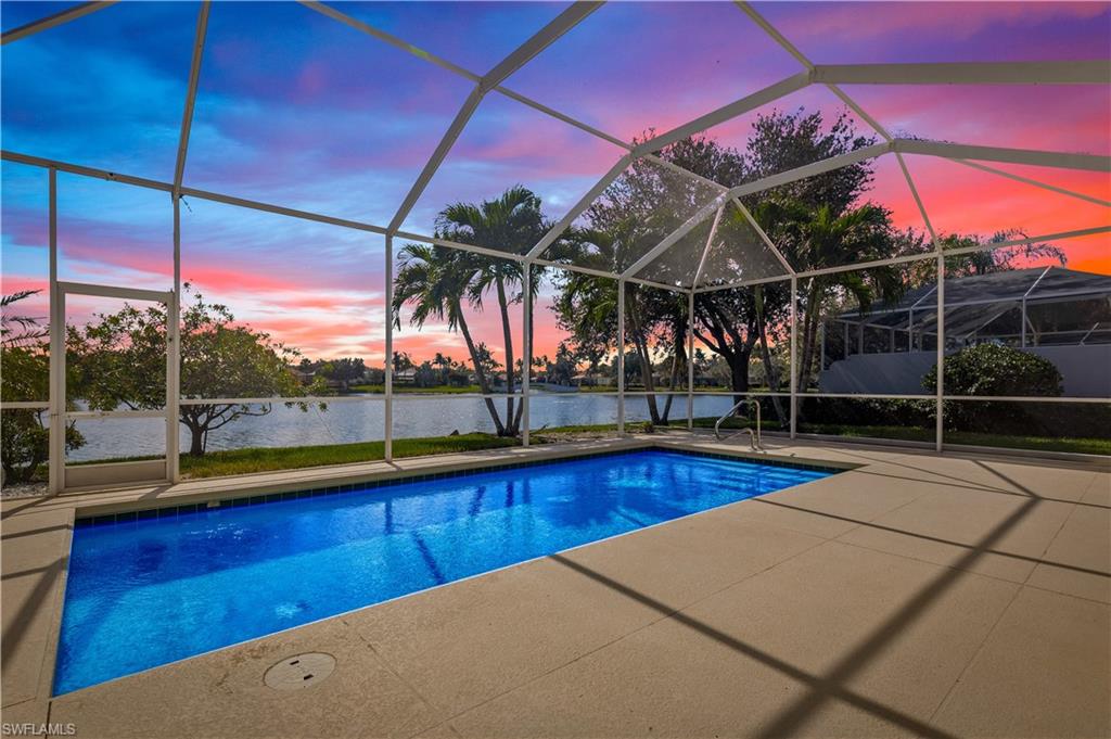 3790 Whidbey Way Naples, FL 34119 - Photo 1 of 49 a view of a swimming pool with a porch