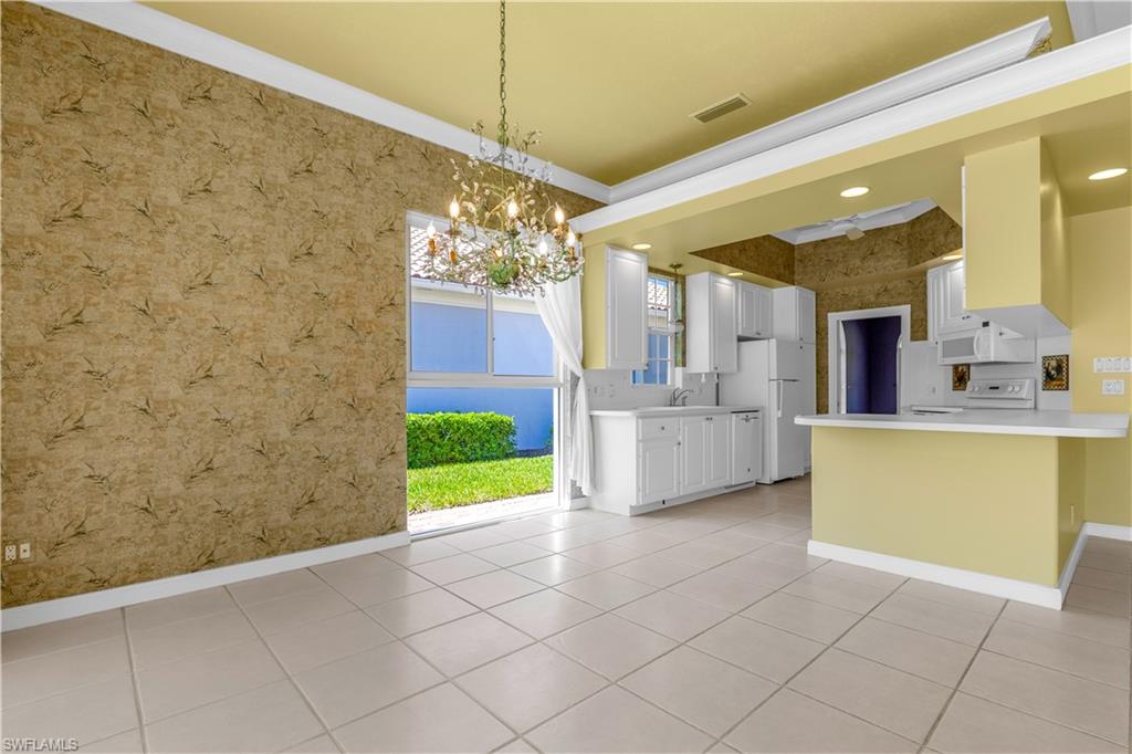3790 Whidbey Way Naples, FL 34119 - Photo 16 of 49 a view of a kitchen with a sink and a refrigerator