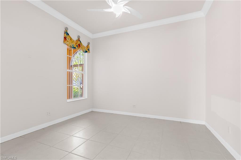 3790 Whidbey Way Naples, FL 34119 - Photo 25 of 49 an empty room with windows and ceiling fan