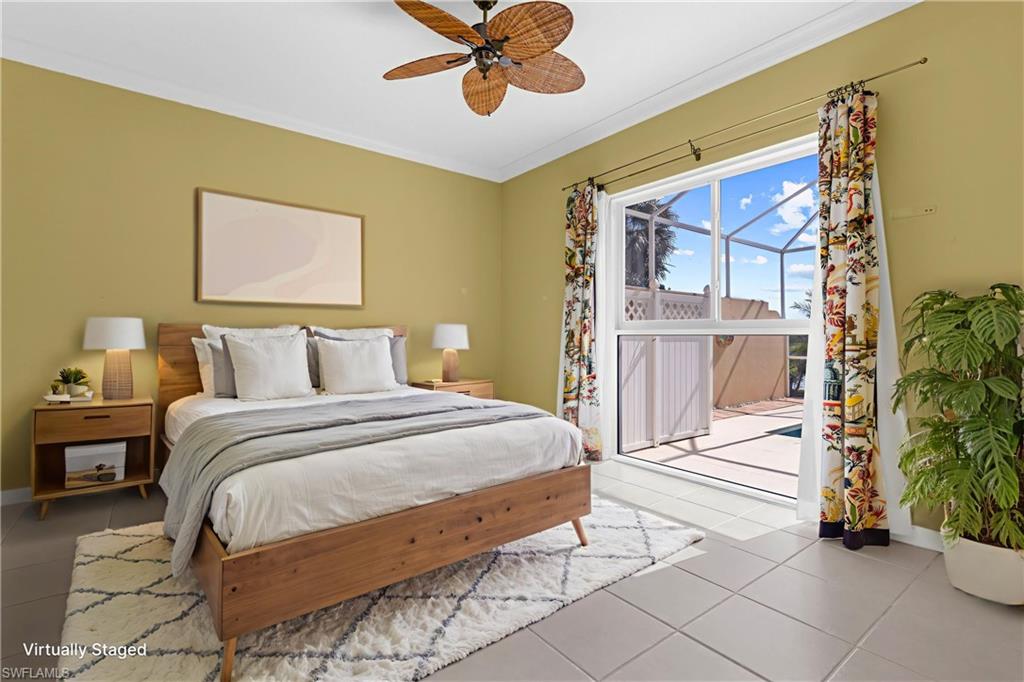 3790 Whidbey Way Naples, FL 34119 - Photo 34 of 49 a bedroom with a bed and a chandelier