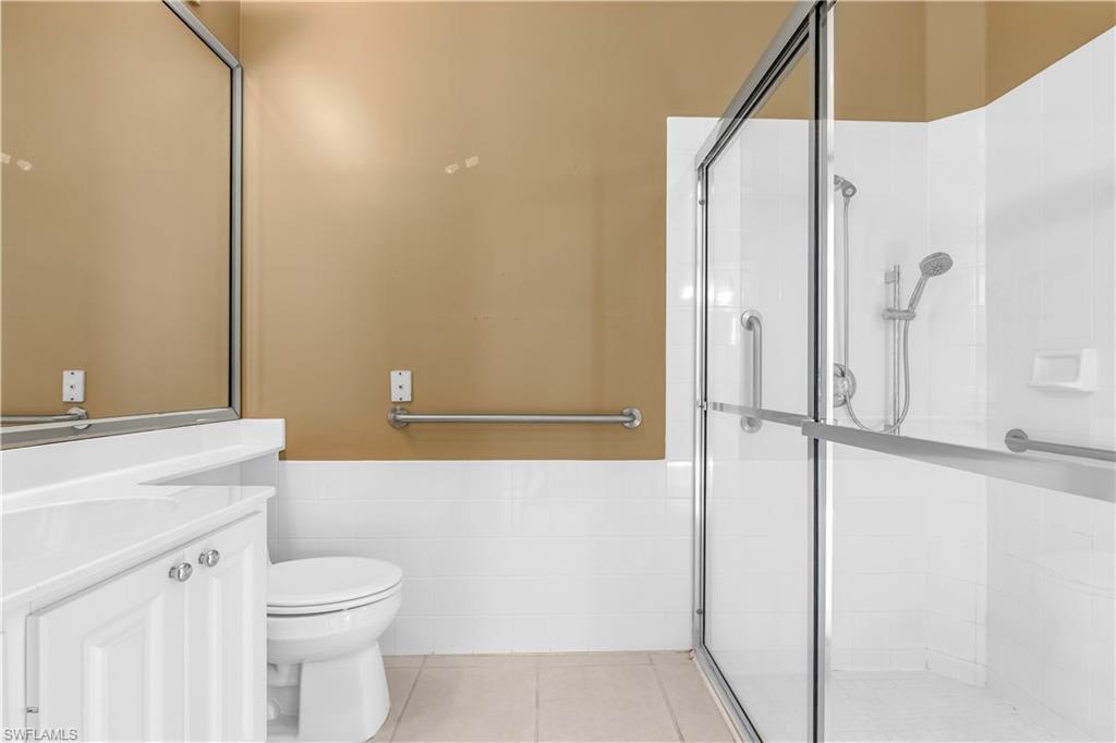 3790 Whidbey Way Naples, FL 34119 - Photo 41 of 49 a bathroom with a granite countertop sink toilet and shower
