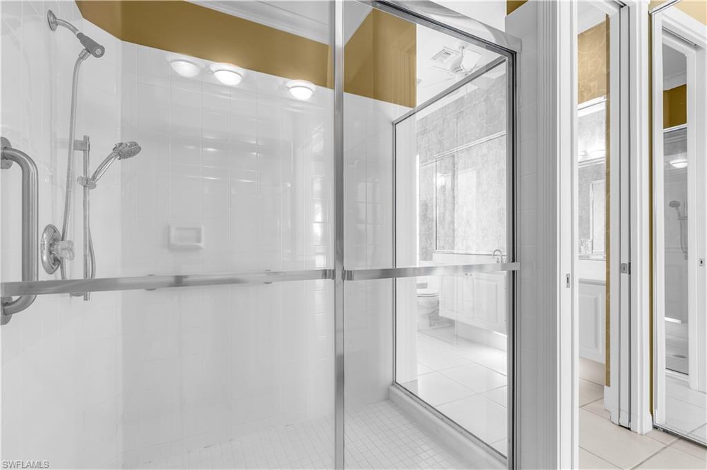 3790 Whidbey Way Naples, FL 34119 - Photo 42 of 49 a bathroom with a glass shower door