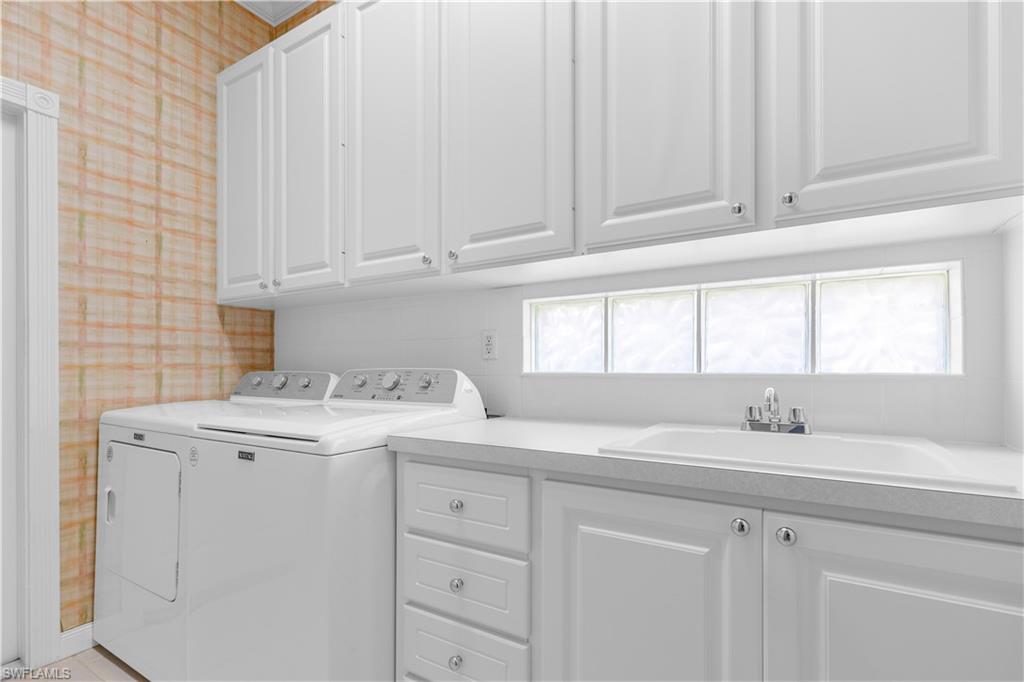 3790 Whidbey Way Naples, FL 34119 - Photo 43 of 49 a kitchen with cabinets appliances a sink and a window