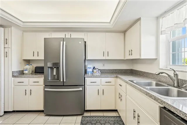 a kitchen with white cabinets and white appliances