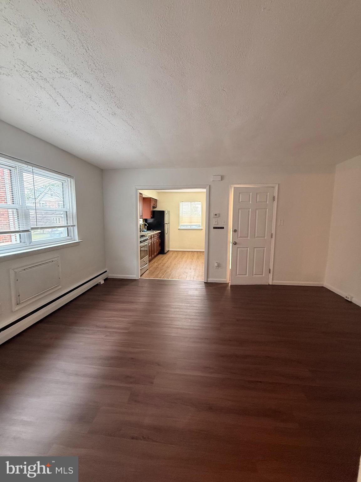 216 Boro Road, Unit A Secane, PA 19018 - Photo 20 of 26 an empty room with wooden floor and windows