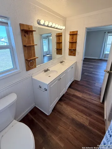 a spacious bathroom with a double vanity sink and a mirror