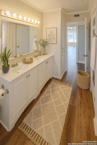a en suite bathroom with a granite countertop sink and a mirror