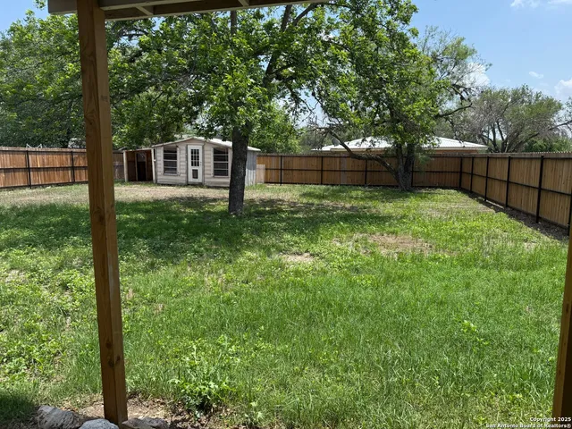 a view of a backyard with a trees and plants