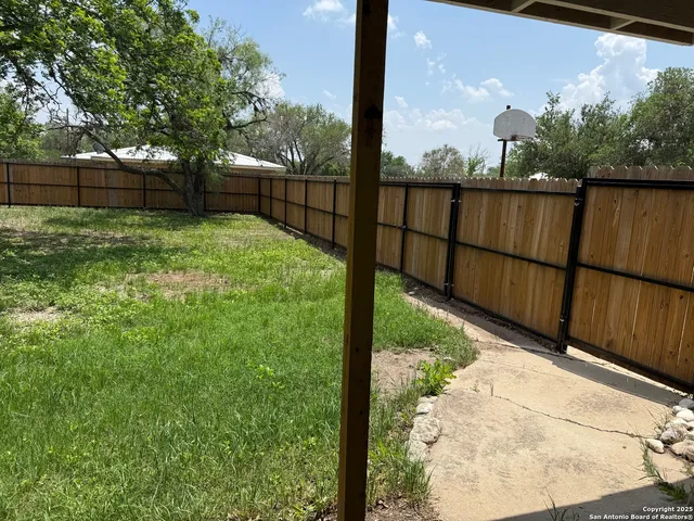 a view of a backyard with a trees and plants
