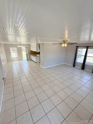 a view of a livingroom with an empty space and a window