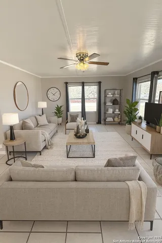 a living room with furniture chandelier and a large window