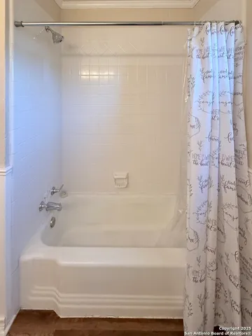 a bathroom with a shower and a bath tub