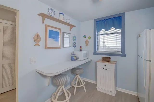 a room with a table chairs and a window