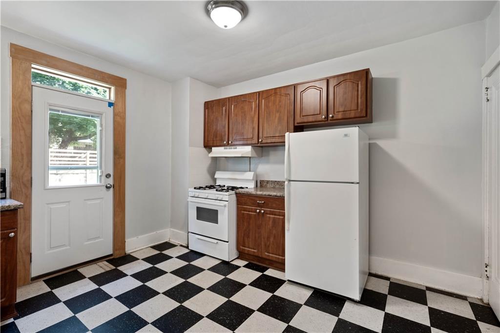 1436 Davis Avenue Pittsburgh, PA 15212 - Photo 12 of 29 a kitchen with a refrigerator a stove and a sink