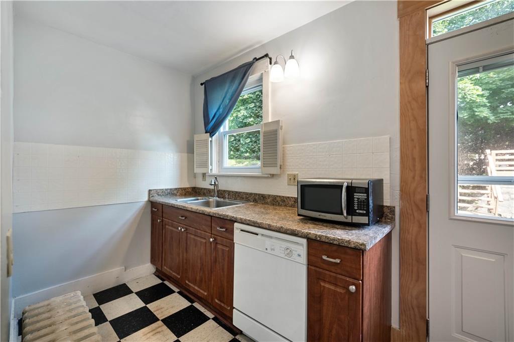 1436 Davis Avenue Pittsburgh, PA 15212 - Photo 13 of 29 a kitchen with a stove microwave and sink