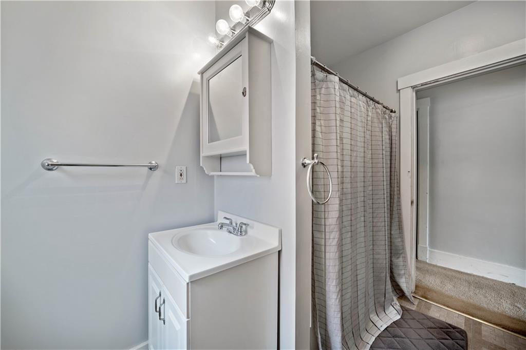 1436 Davis Avenue Pittsburgh, PA 15212 - Photo 20 of 29 a bathroom with a sink a mirror and shower
