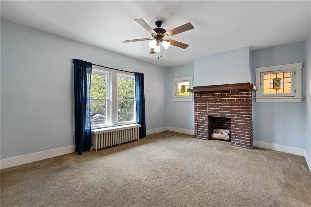 1436 Davis Avenue Pittsburgh, PA 15212 - Photo 21 of 29 an empty room with fireplace and windows