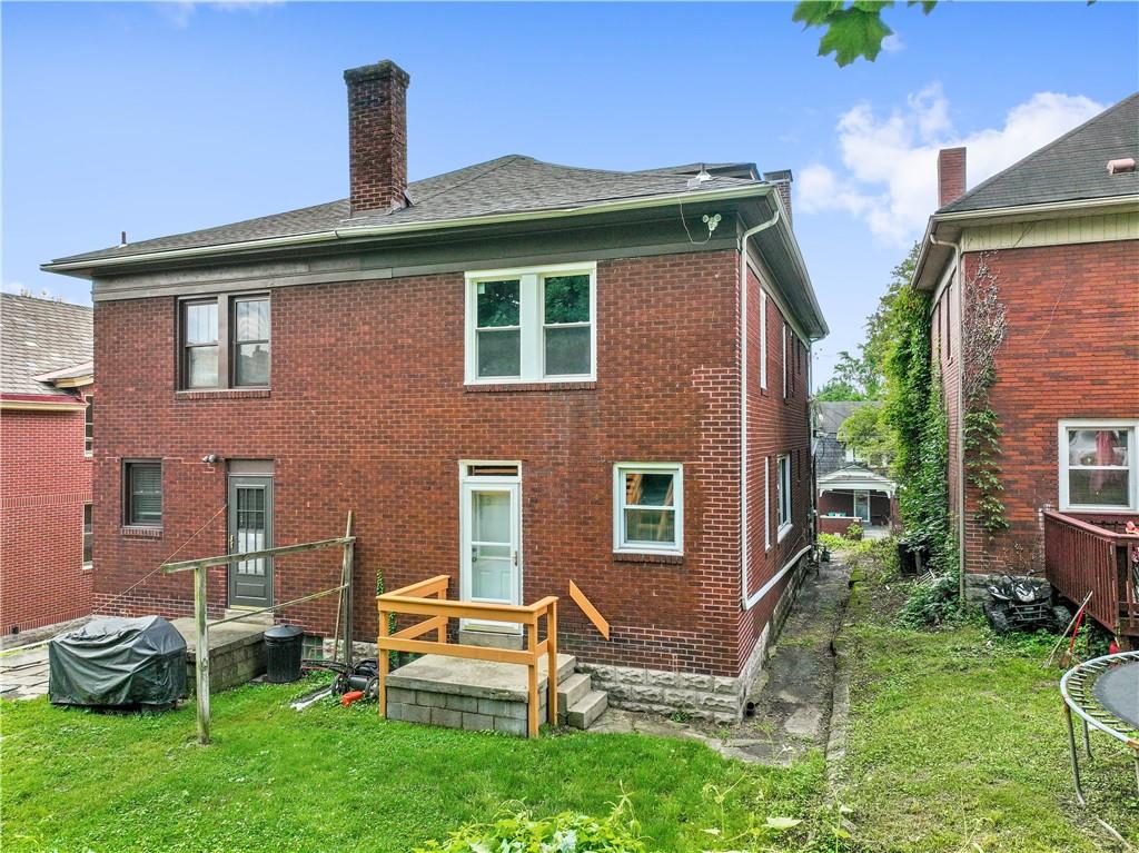 1436 Davis Avenue Pittsburgh, PA 15212 - Photo 25 of 29 a front view of a house with a yard