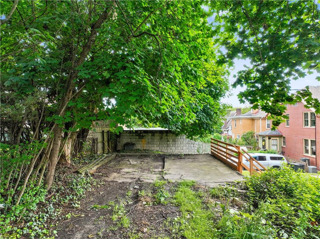 1436 Davis Avenue Pittsburgh, PA 15212 - Photo 27 of 29 a view of a backyard with plants and a large tree