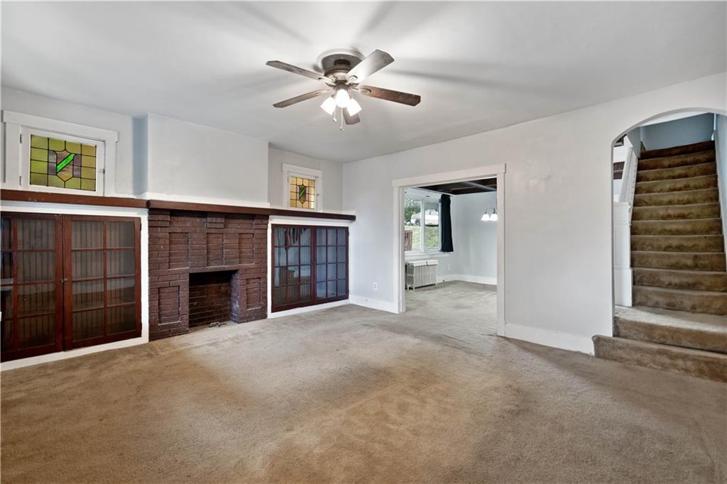 1436 Davis Avenue Pittsburgh, PA 15212 - Photo 4 of 29 a view of an empty room with a fireplace and a window