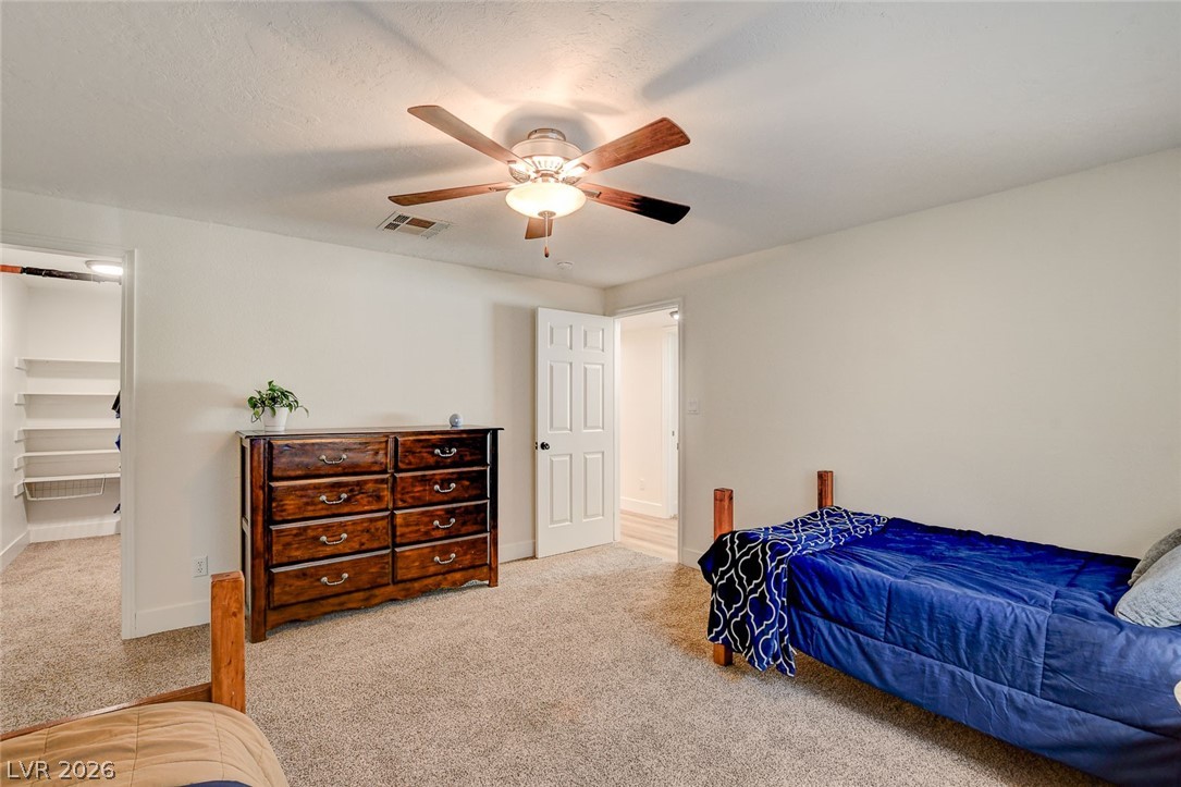 4362 Thistle Street Logandale, NV 89021 - Photo 57 of 99 A restful chamber offering neutral carpet and a lighted ceiling fan for comfort.