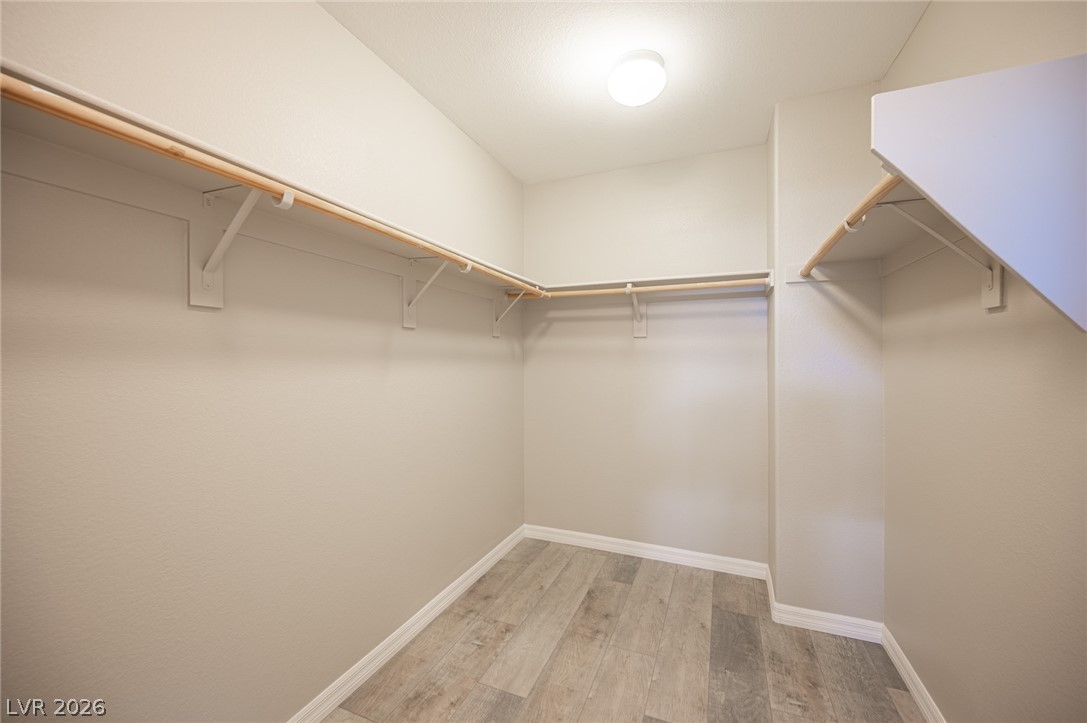 9916 Sable Point Street Las Vegas, NV 89178 - Photo 51 of 73 Ample hanging space and durable flooring define this well-appointed closet.