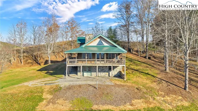 a front view of a house with a large trees