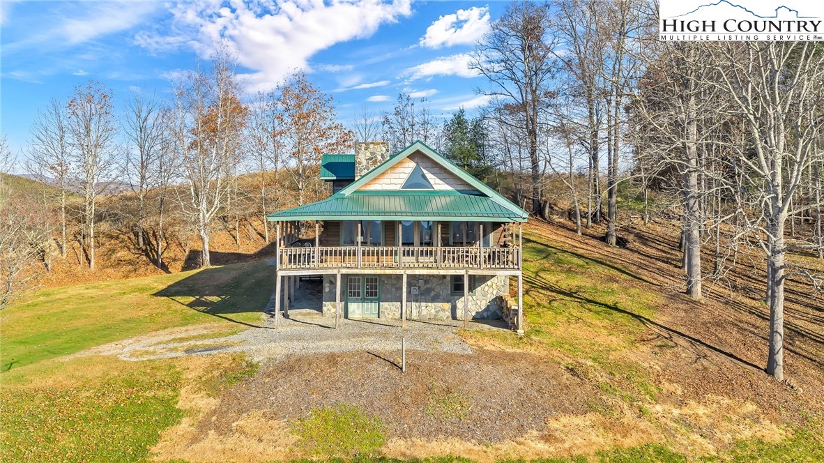 a front view of a house with a large trees