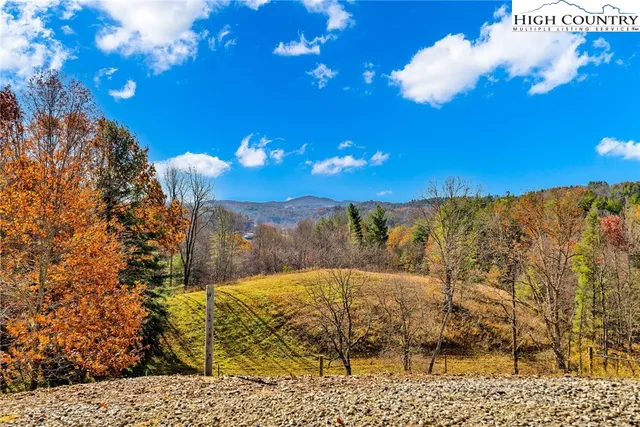 a view of a balcony with a yard