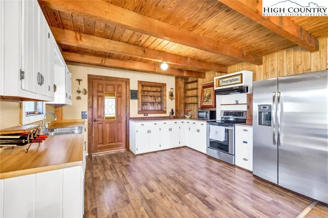 a kitchen with stainless steel appliances a refrigerator and a stove