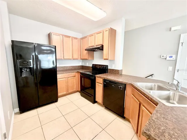 a kitchen with a refrigerator sink and stove