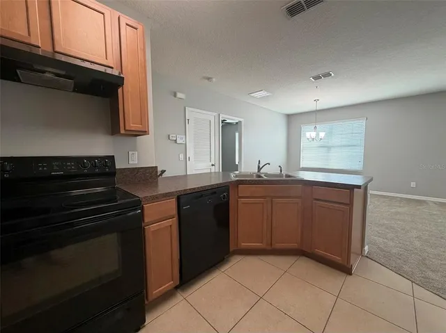a kitchen with granite countertop a stove and a sink