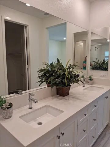a bathroom with a sink double vanity and a mirror