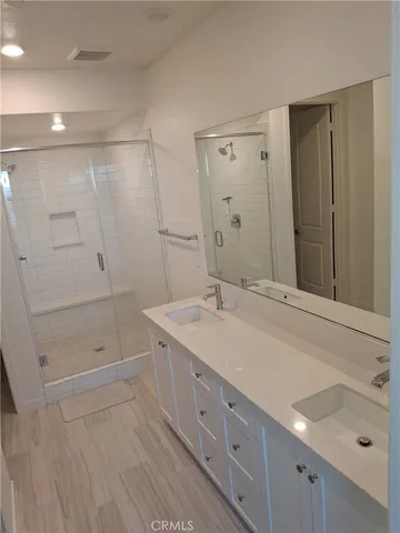 a bathroom with a double vanity sink and mirror