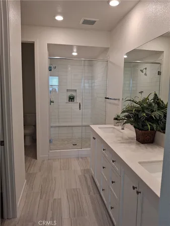a bathroom with a shower sink and mirror