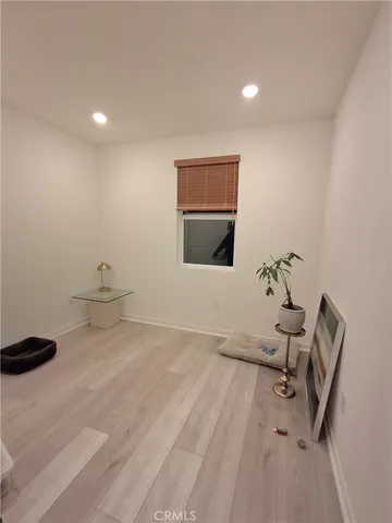 a view of a room with gym equipment and a potted plant