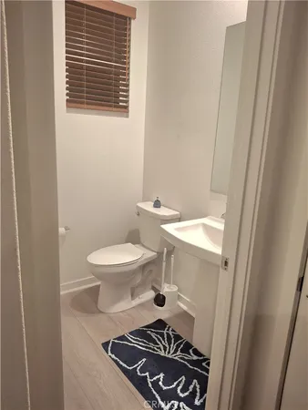 a bathroom with a toilet and a mirror