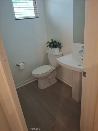a white toilet sitting next to a bathroom sink