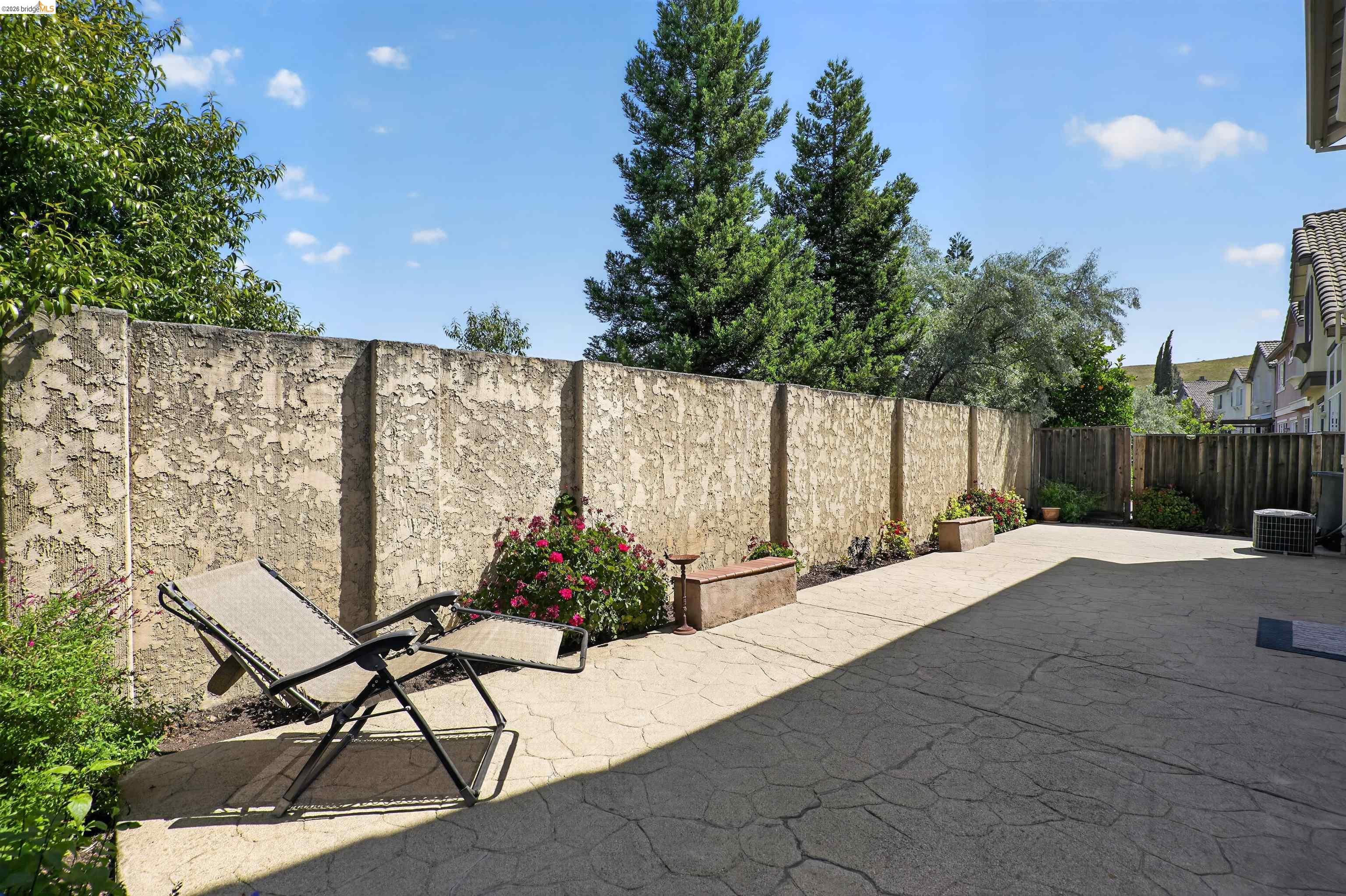 1221 Andrea Way Vallejo, CA 94591 - Photo 29 of 29 Expansive patio area featuring textured stucco privacy walls and concrete paver flooring