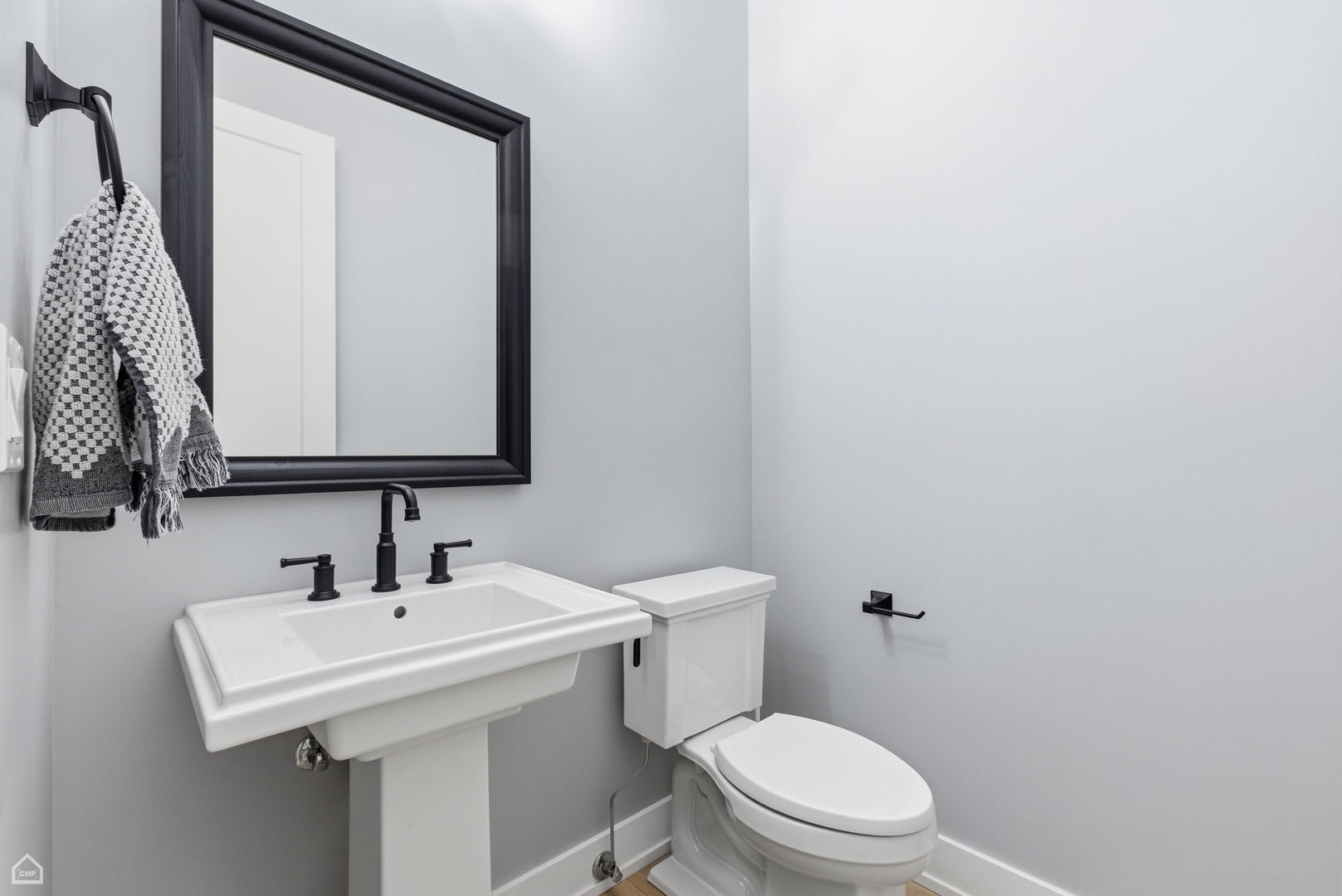 Undisclosed Address Chicago, IL 60625 - Photo 11 of 25 a bathroom with a toilet sink and mirror