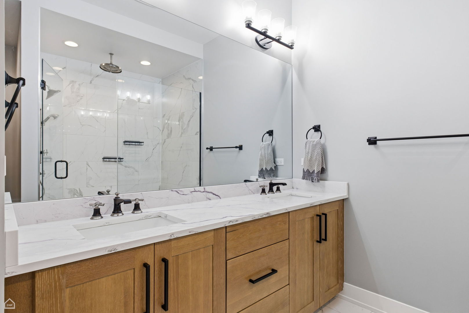 Undisclosed Address Chicago, IL 60625 - Photo 16 of 25 a bathroom with a sink double vanity and a mirror