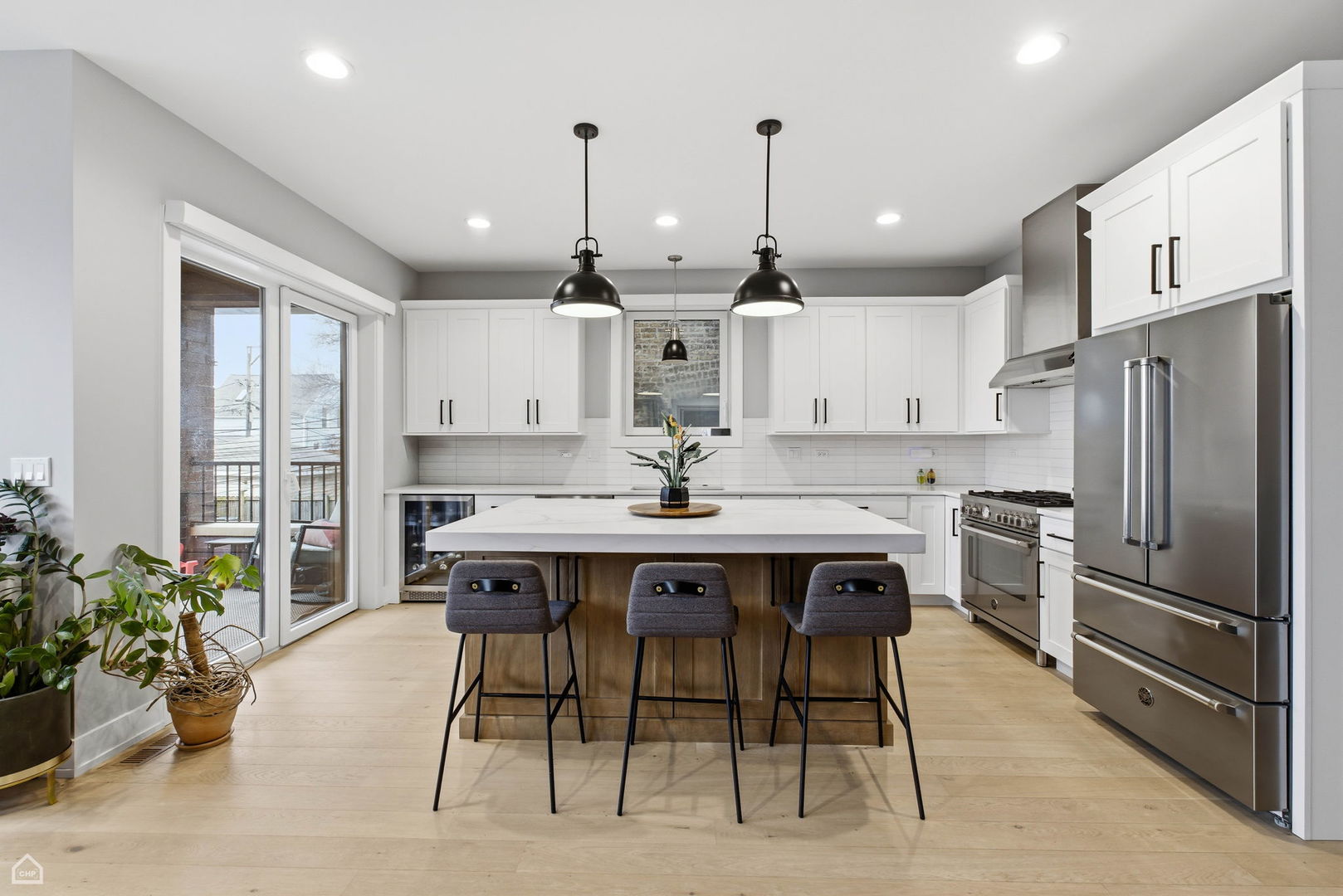 Undisclosed Address Chicago, IL 60625 - Photo 8 of 25 a kitchen with stainless steel appliances kitchen island granite countertop a table chairs and a refrigerator