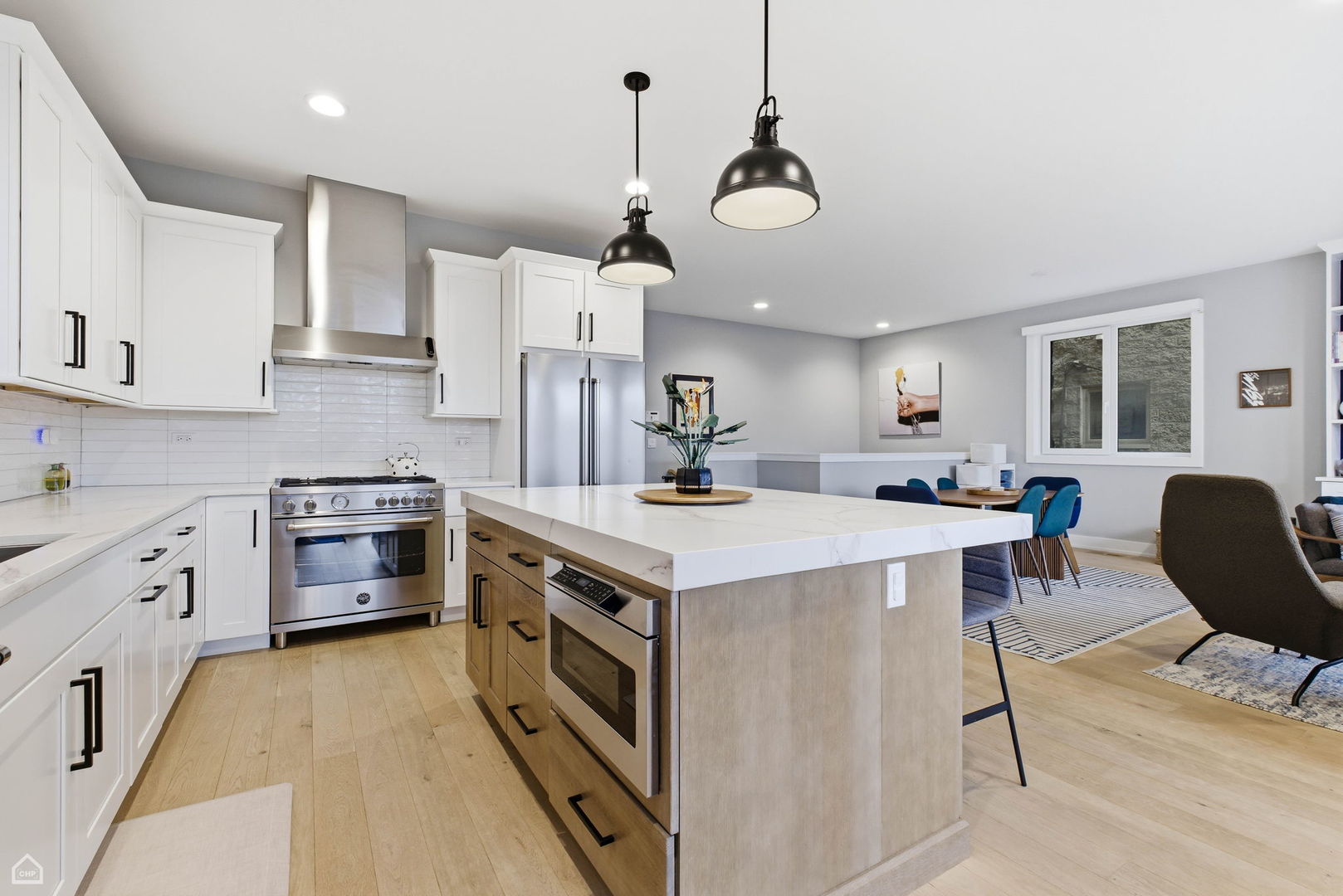 Undisclosed Address Chicago, IL 60625 - Photo 9 of 25 a kitchen with a stove kitchen island and stainless steel appliances
