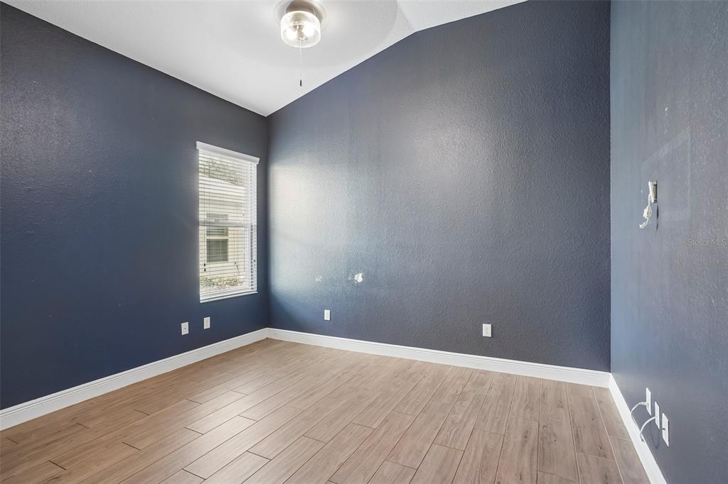 10339 Addison Shore Way Oxford, FL 34484 - Photo 48 of 54 an empty room with wooden floor and windows