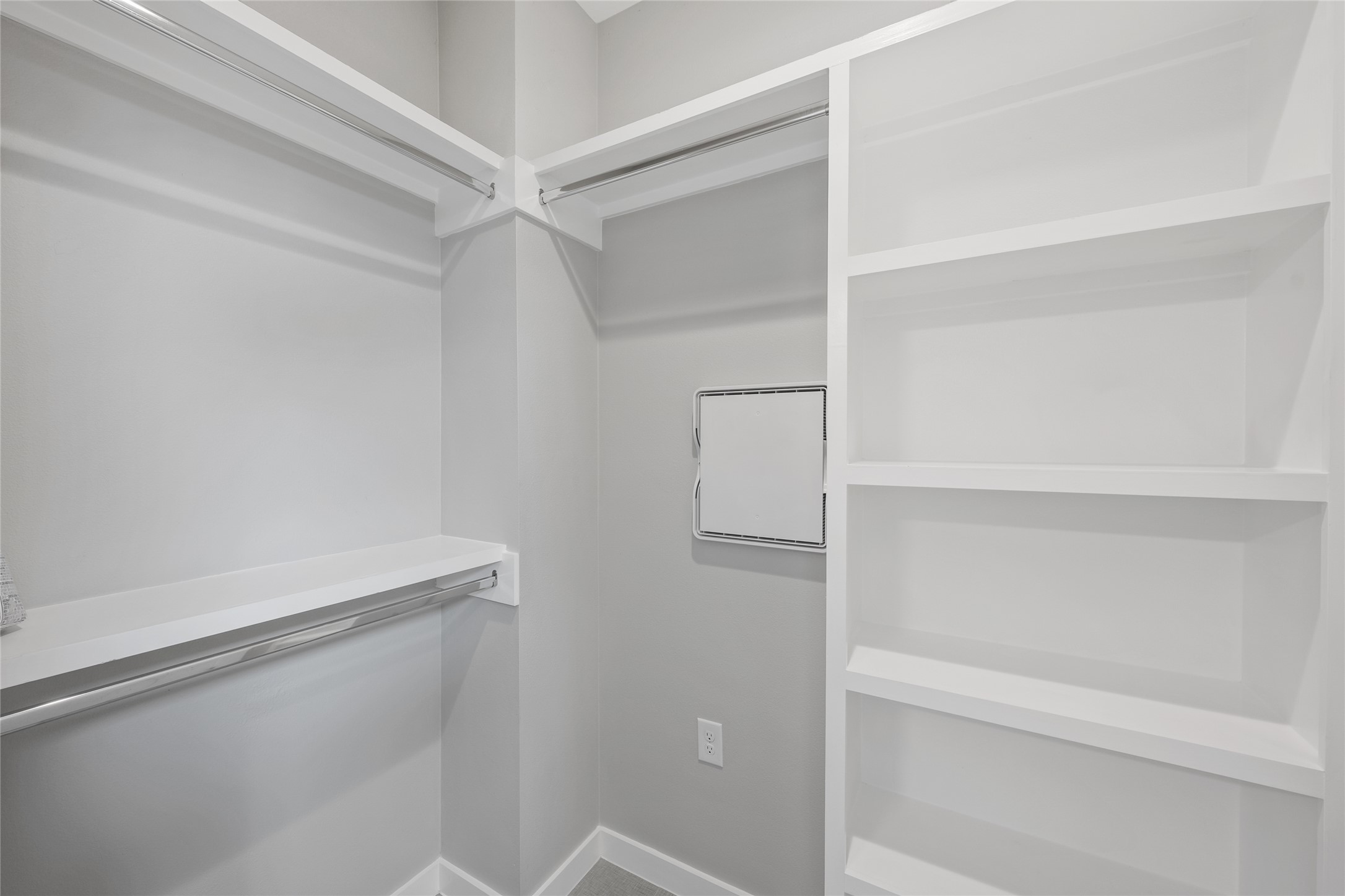 2108 Tillery Street, Unit 16 Austin, TX 78723 - Photo 14 of 15 Walk-in closet featuring built-in shelving, multiple hanging rods, and light gray wall tones