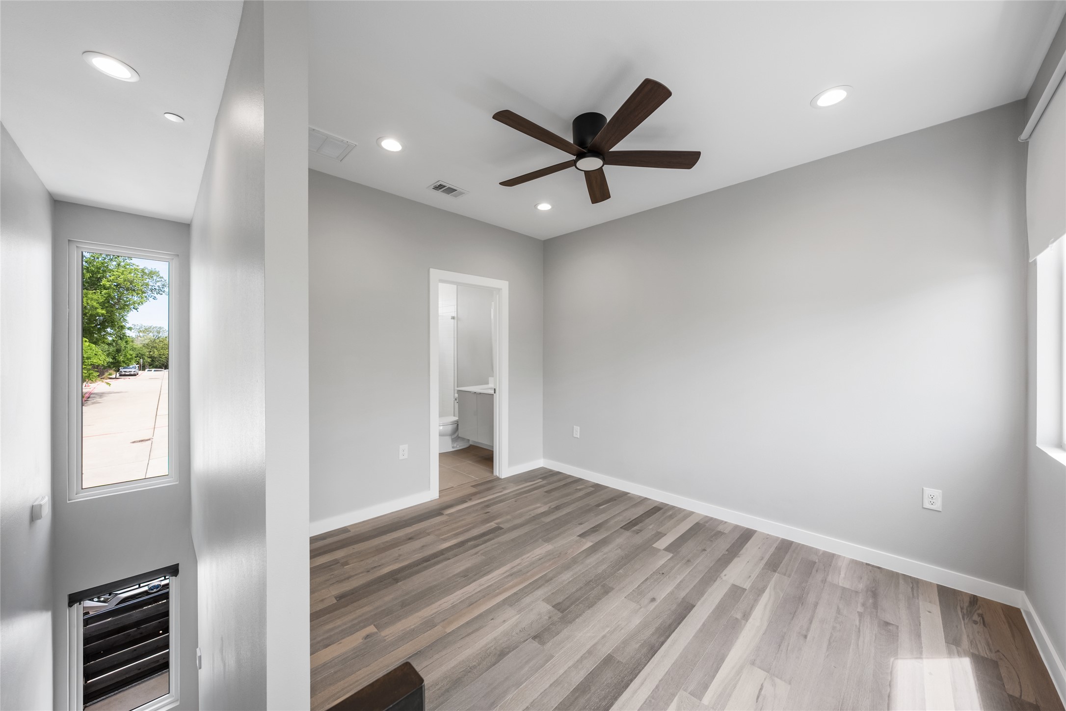 2108 Tillery Street, Unit 16 Austin, TX 78723 - Photo 9 of 15 Bright interior space featuring wood-finish flooring, recessed lighting, and a contemporary ceiling fan