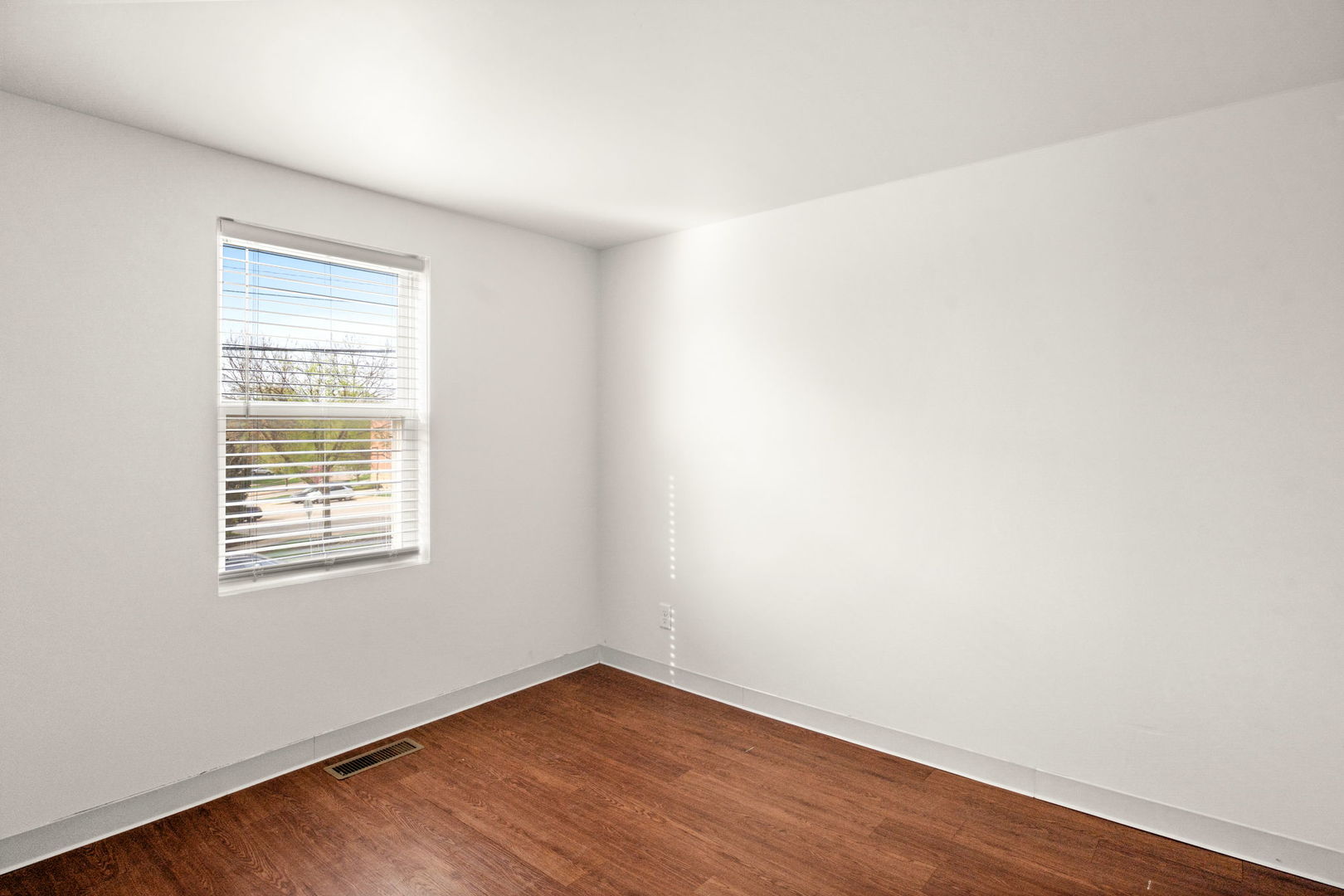 827 East Wilson Street, Unit B Batavia, IL 60510 - Photo 12 of 17 an empty room with wooden floor and a window