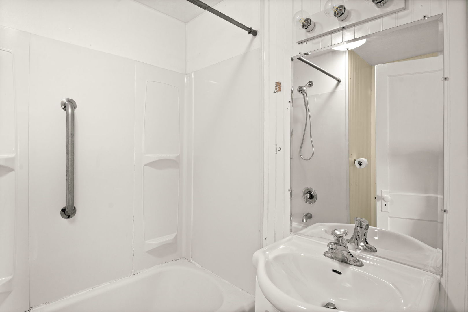 827 East Wilson Street, Unit B Batavia, IL 60510 - Photo 14 of 17 a bathroom with a sink a shower and a mirror