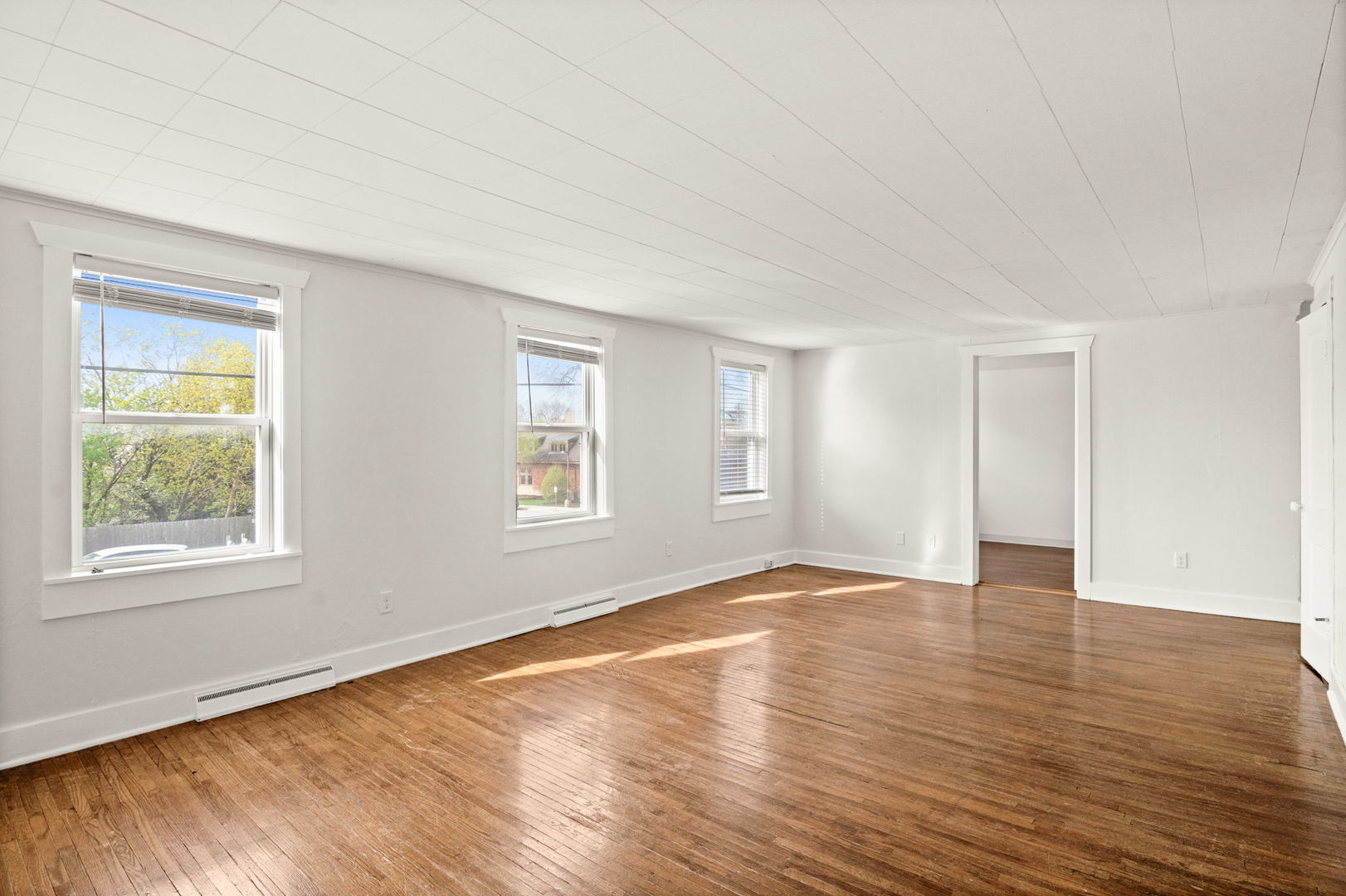 827 East Wilson Street, Unit B Batavia, IL 60510 - Photo 6 of 17 a view of an empty room with wooden floor and a window
