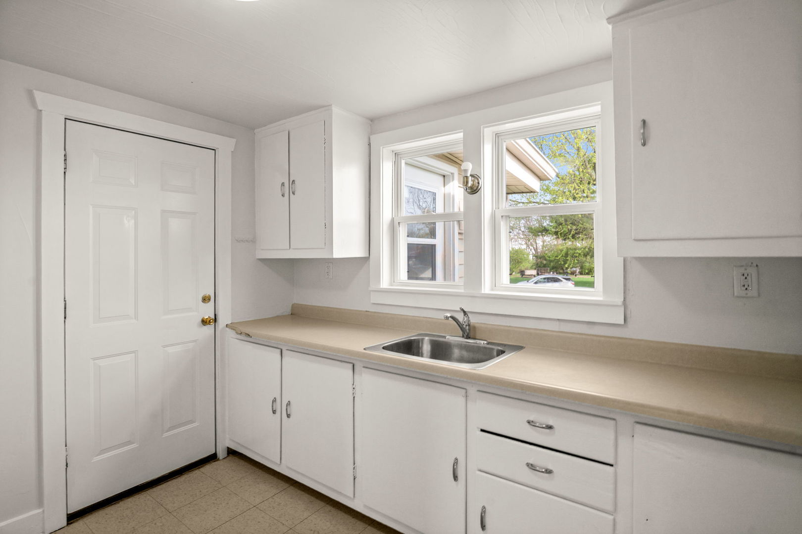 827 East Wilson Street, Unit B Batavia, IL 60510 - Photo 8 of 17 a kitchen with white cabinets and a sink